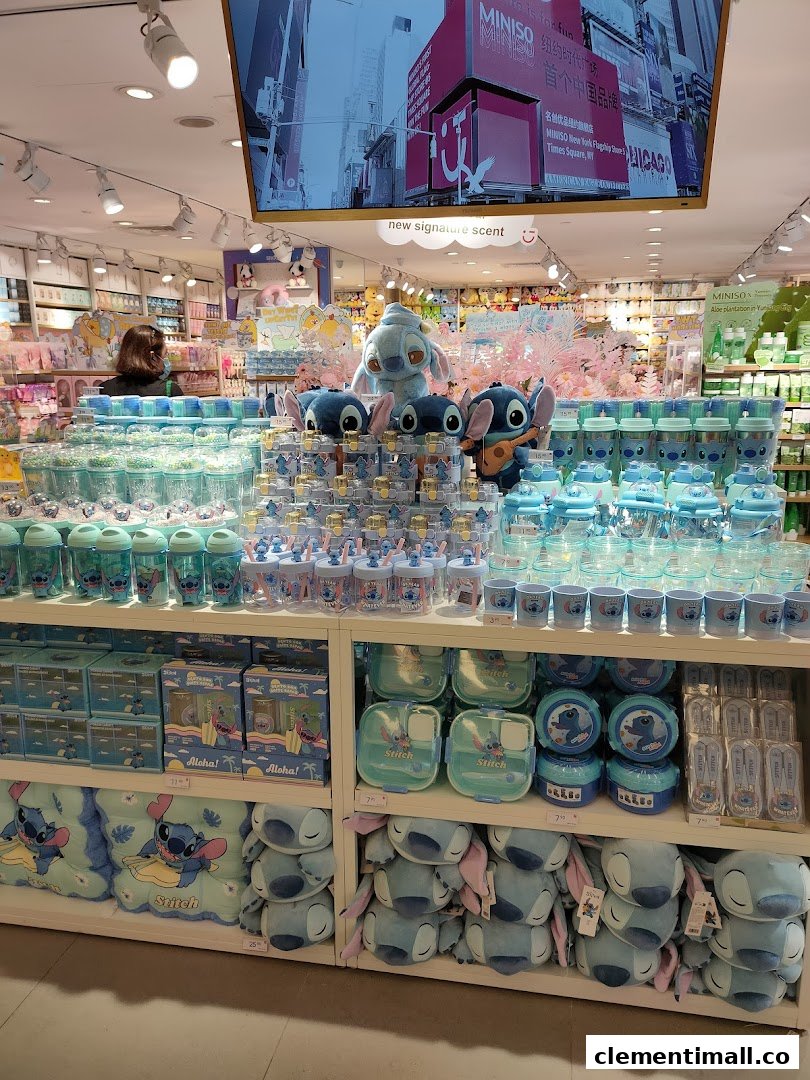 A vibrant display of Stitch-themed merchandise, including plush toys and drinkware, inside a MINISO store.