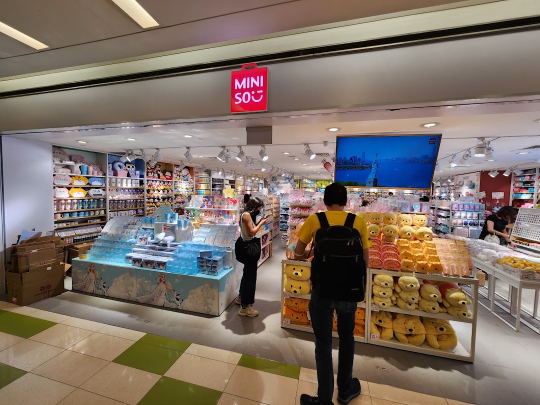 The vibrant MINISO shop entrance, showcasing a wide array of affordable lifestyle products and shoppers.