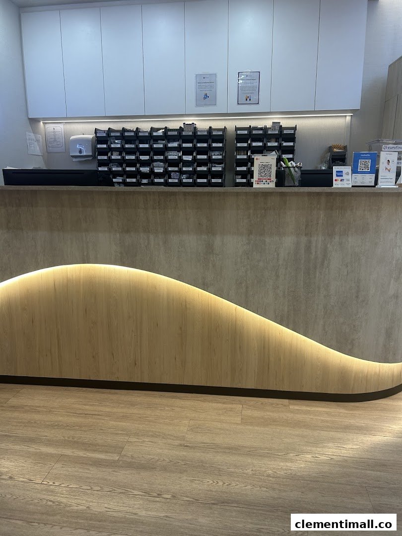 A clean and modern reception desk area inside Minmed Clinic Clementi, featuring a wave-patterned counter.