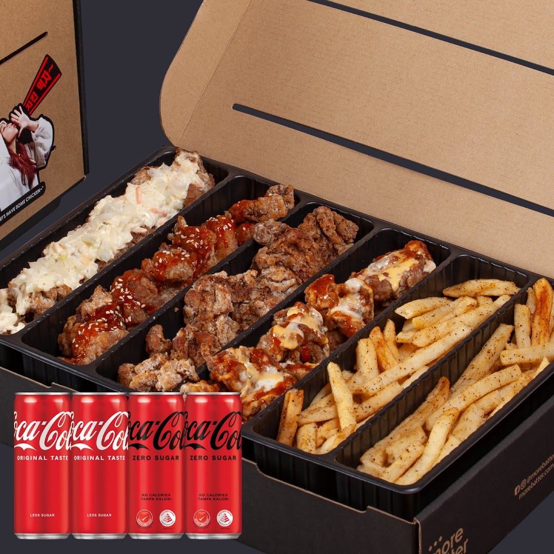 A variety box of fried chicken, fries, and Coca-Cola cans, perfect for sharing.