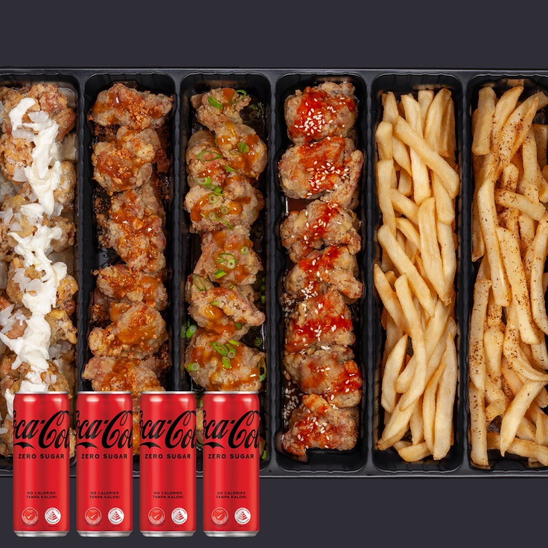 A variety of fried chicken flavors, golden fries, and Coca-Cola Zero Sugar cans in a meal set.