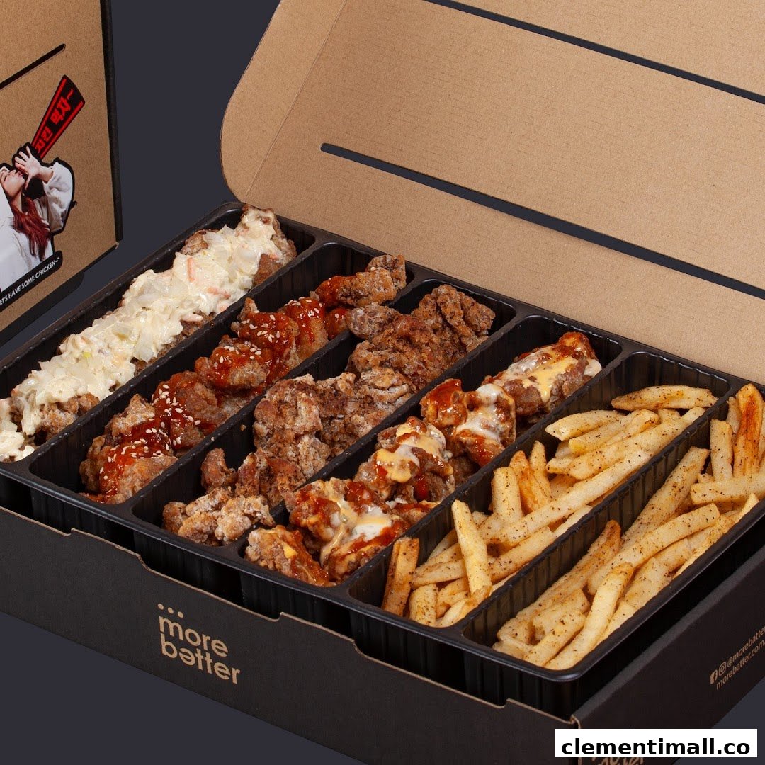 A large box of assorted fried chicken pieces with various sauces and seasoned fries from More Batter.