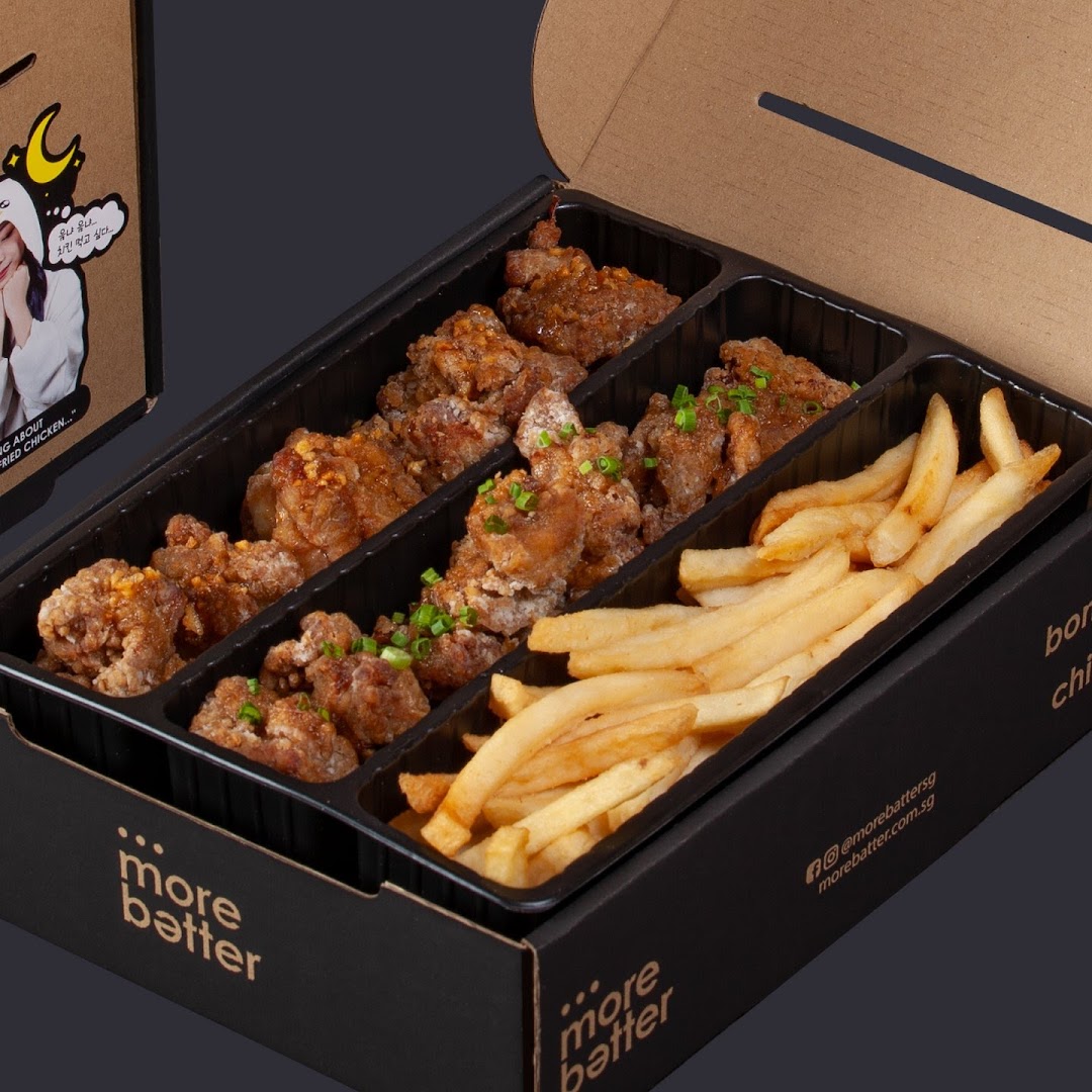 A takeout box filled with crispy fried chicken pieces and golden french fries from More Batter.