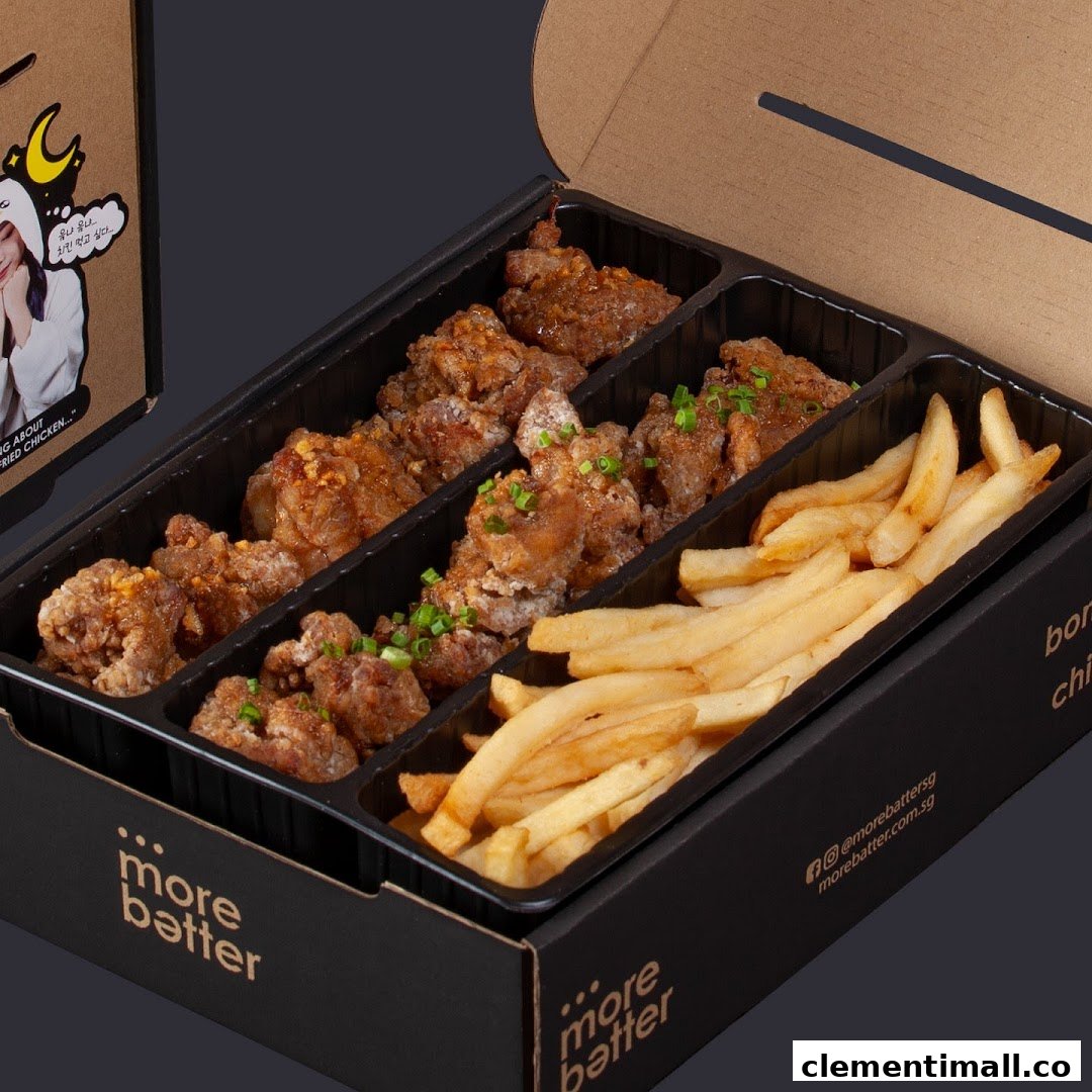 A takeout box filled with crispy fried chicken pieces and golden french fries from More Batter.
