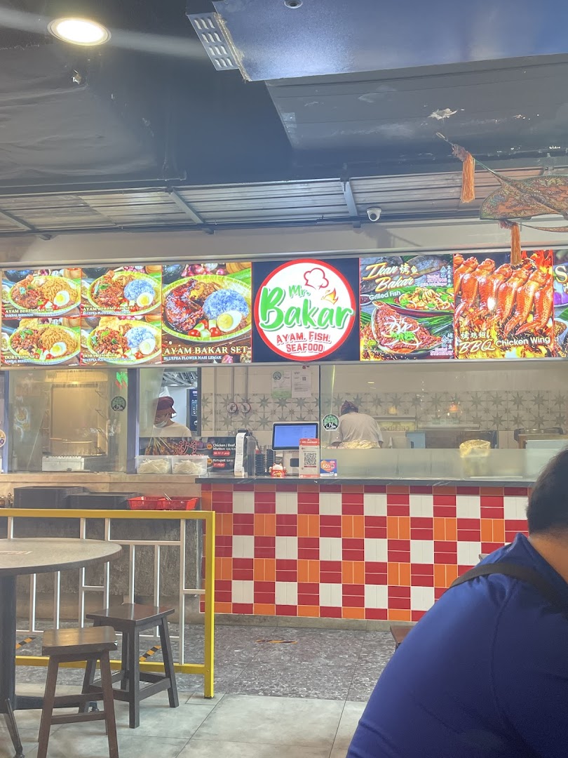 A vibrant display of Mr Bakar's grilled Ayam, Fish, and Seafood dishes, showcasing their menu offerings.