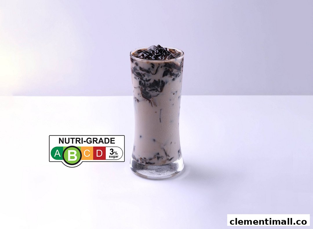 A tall glass of a milky beverage with dark jelly pieces and a 'Nutri-Grade B' label.