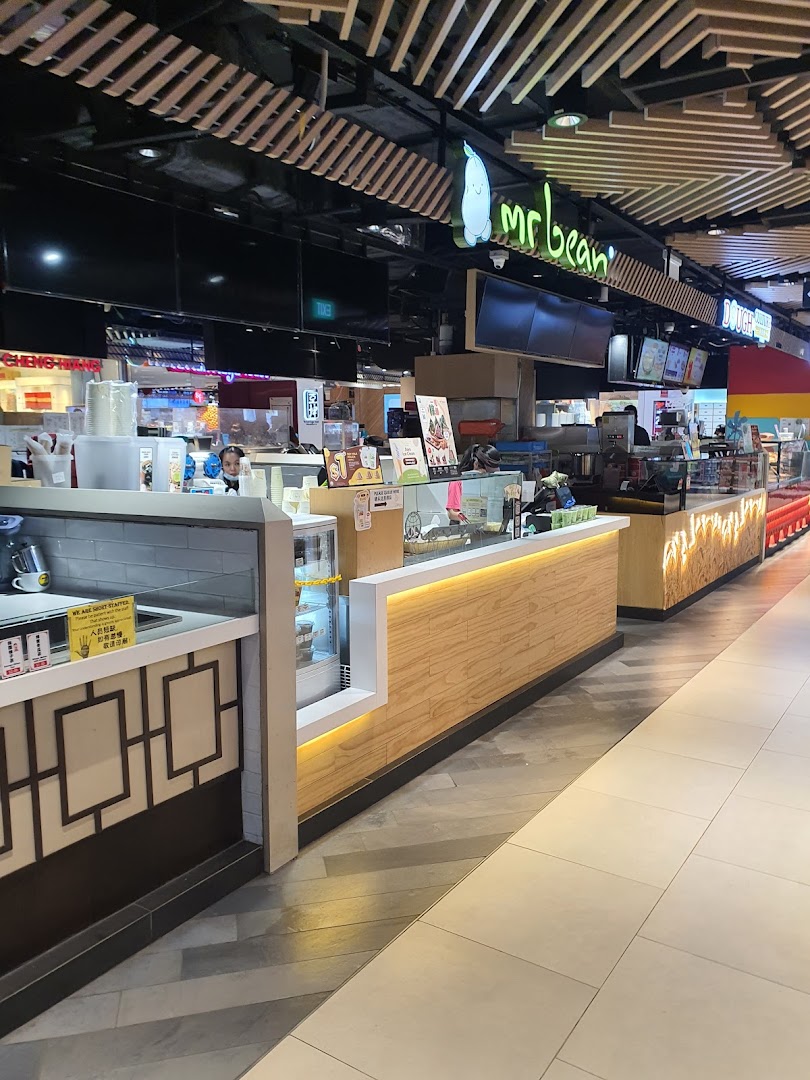 An interior view of the Mr Bean food stall counter, showcasing display cases and staff.