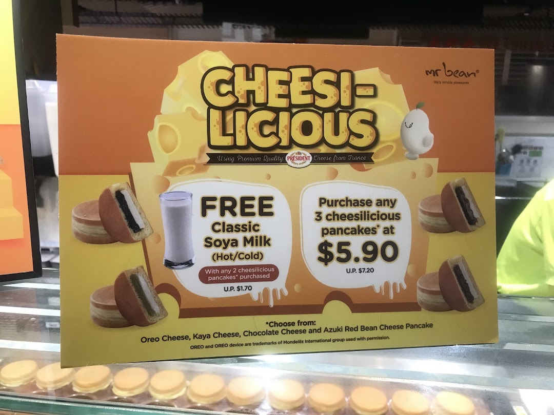 A promotional sign for Mr Bean's 'Cheesilicious' pancakes, featuring special offers and flavors.