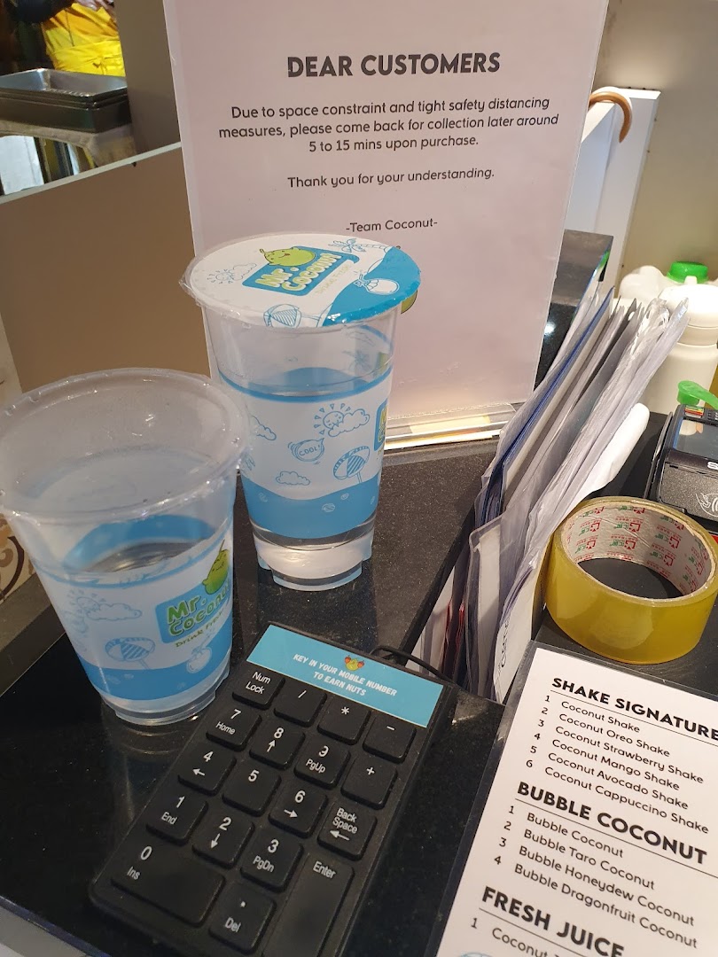 A Mr Coconut counter displaying customer information, loyalty keypad, and a partial menu of refreshing shakes and bubble coconut drinks.