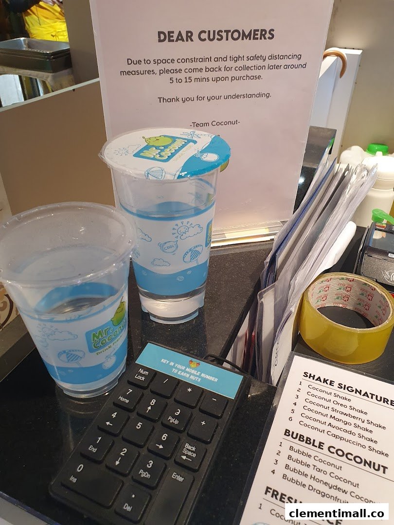 A Mr Coconut counter displaying customer information, loyalty keypad, and a partial menu of refreshing shakes and bubble coconut drinks.