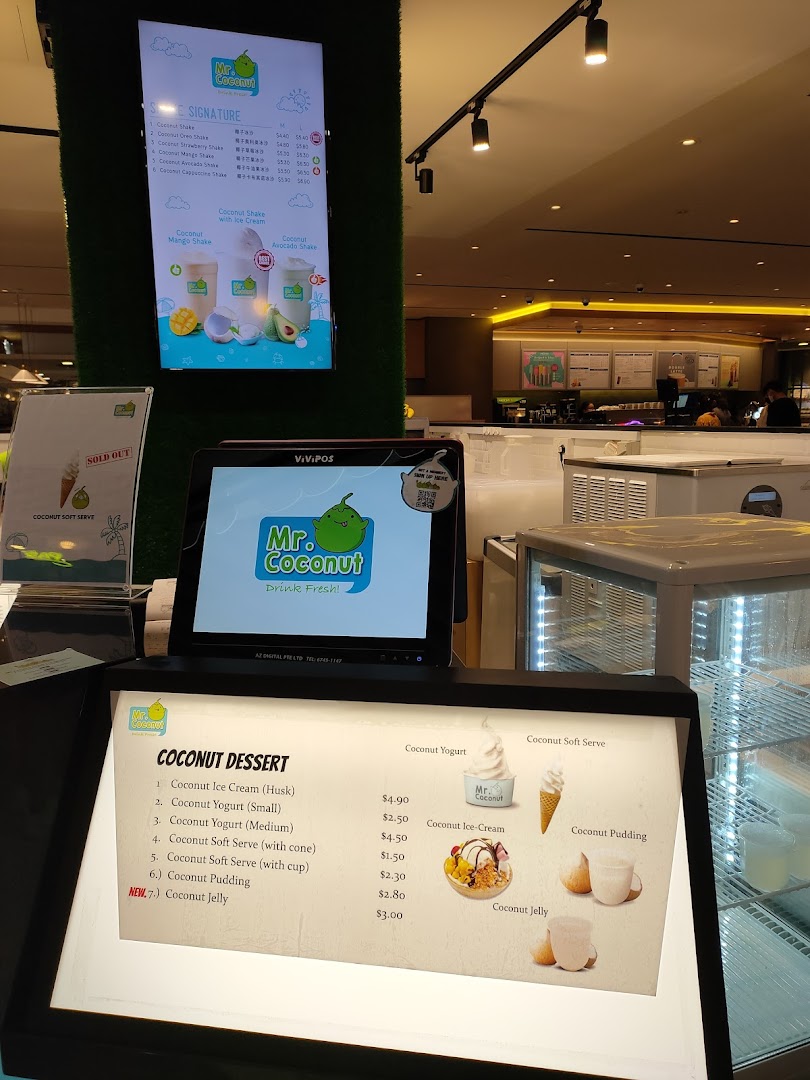 A close-up view of Mr Coconut's digital and lighted menus displaying various coconut drinks and desserts.