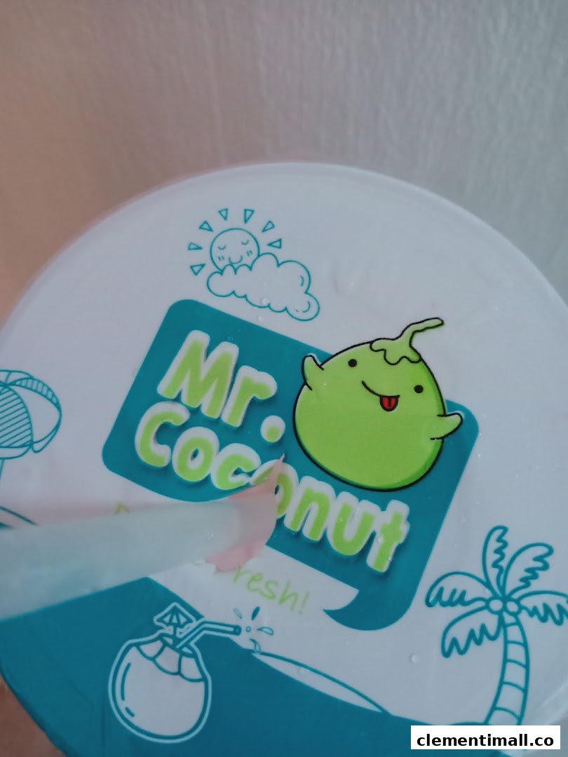 Close-up of a Mr Coconut drink cup lid featuring its logo and a straw.