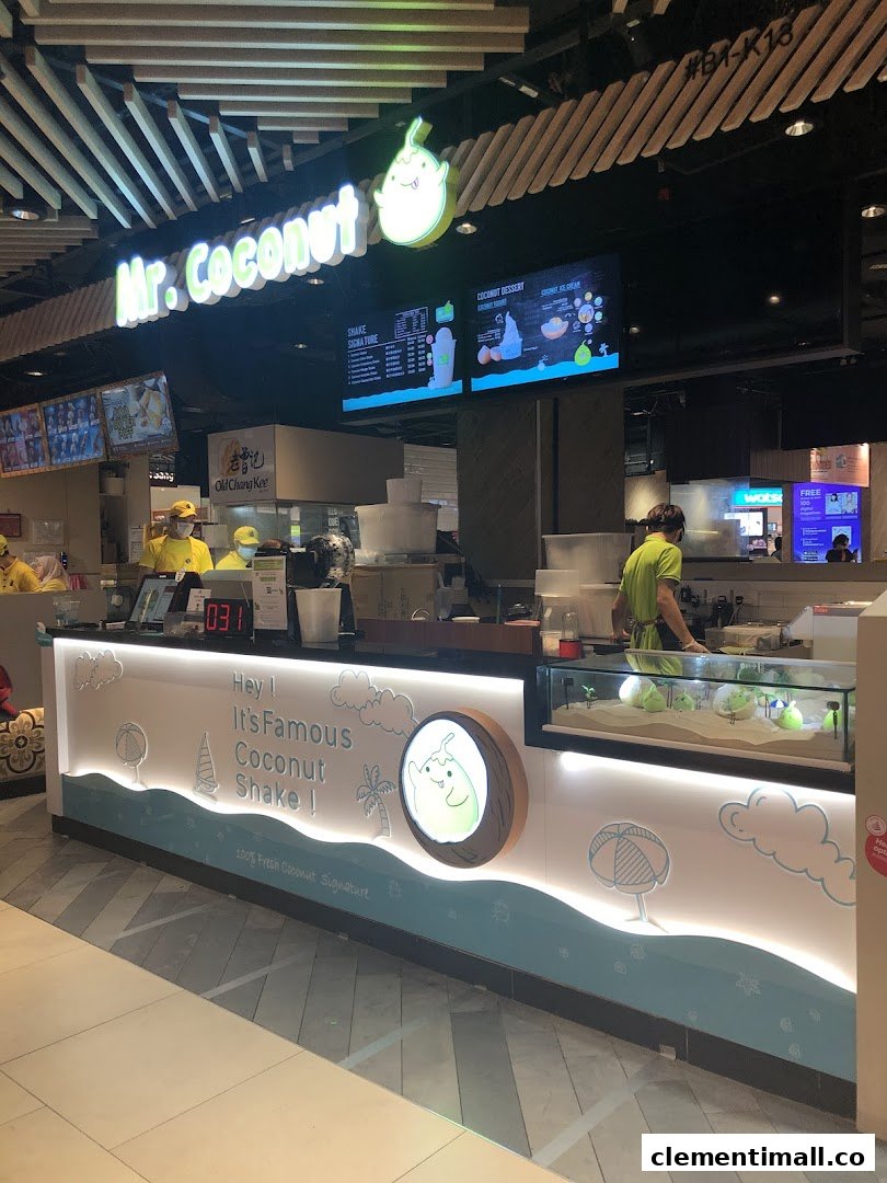 A vibrant Mr Coconut shop counter with staff, featuring its signature coconut shakes and desserts.