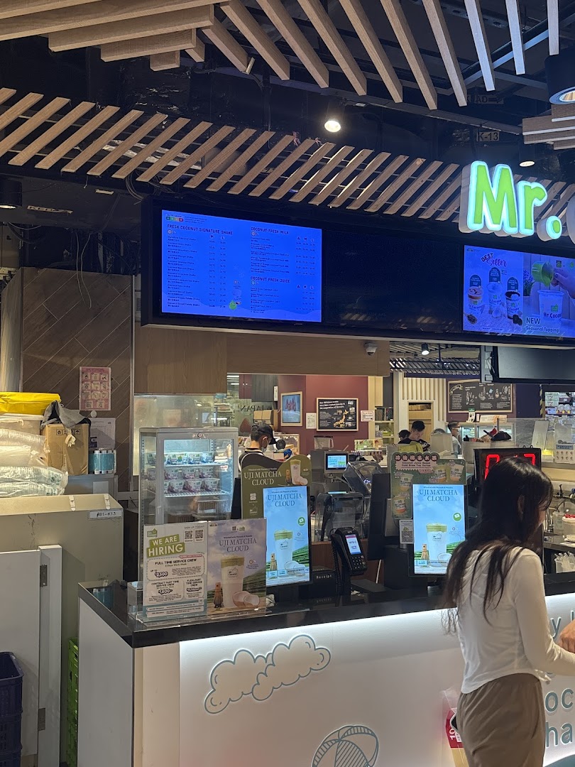 Interior view of Mr Coconut shop featuring a digital menu board and service counter.