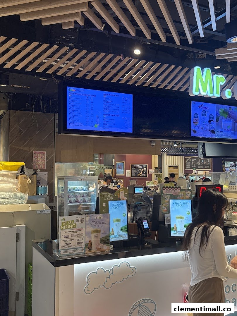 Interior view of Mr Coconut shop featuring a digital menu board and service counter.