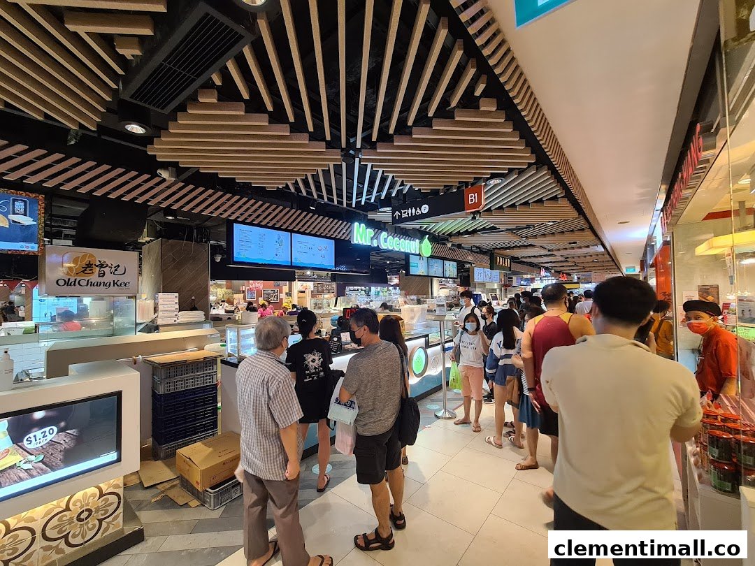 Customers queueing at popular food stalls, including Mr Coconut, in a busy shopping mall food court.