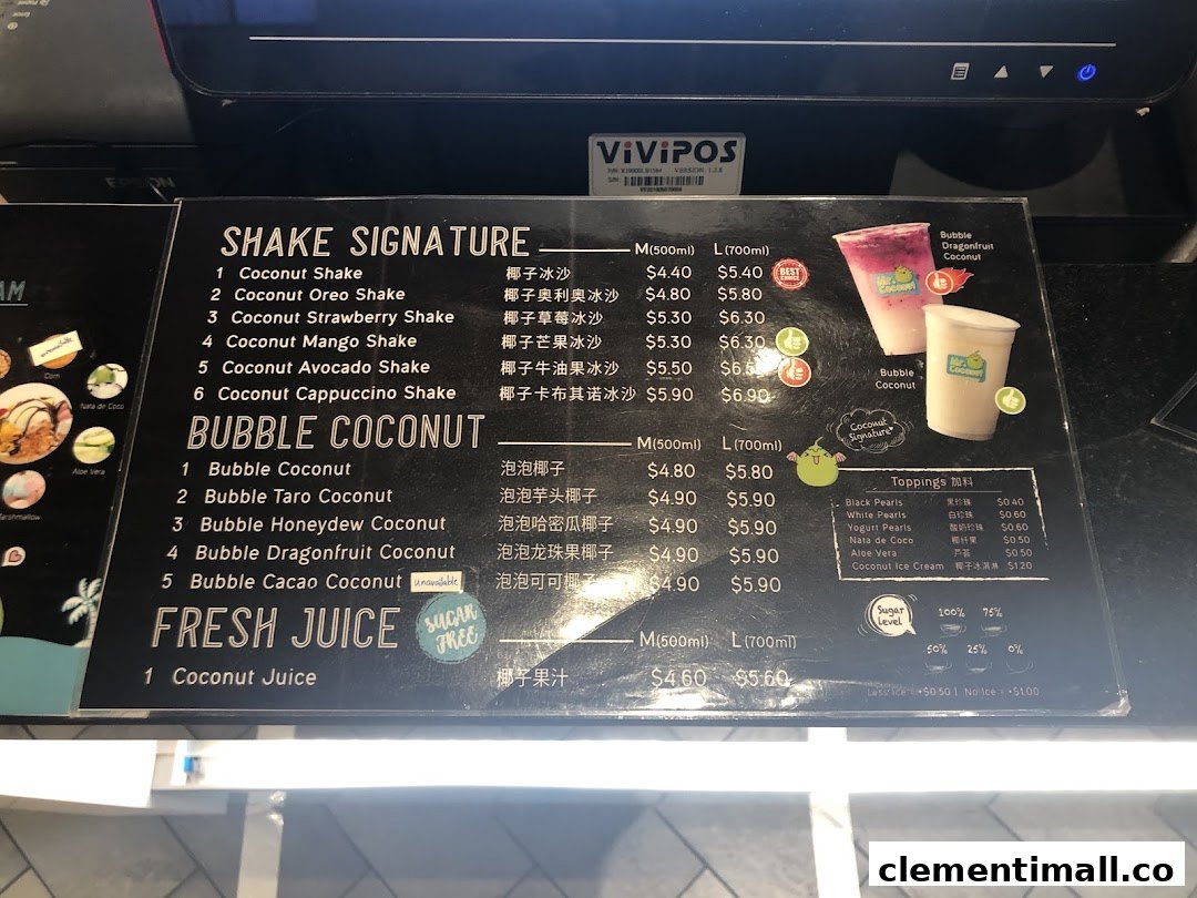 A detailed menu board displaying various coconut shakes, bubble coconut drinks, fresh juice, and toppings.