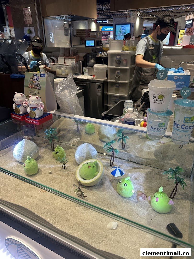 Staff prepare fresh coconut drinks behind a counter with a fun, beach-themed display at Mr Coconut.