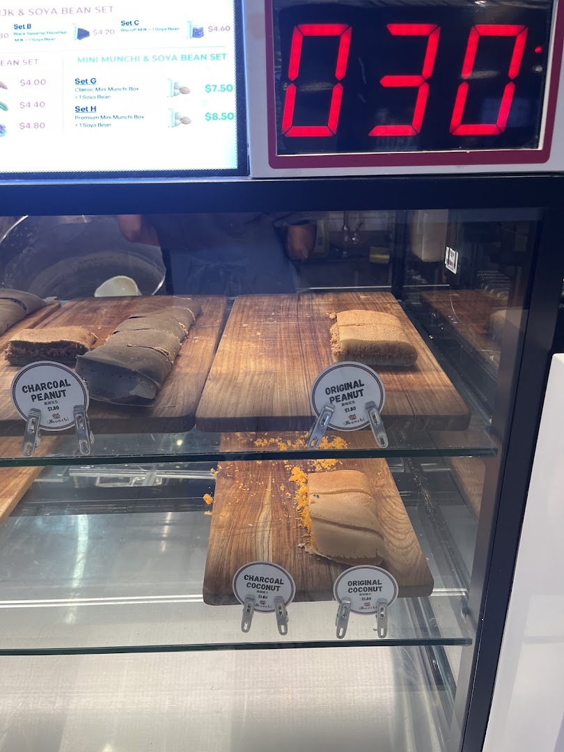 A vibrant display of Munchi Pancakes in various flavors, with a menu board showing sets.