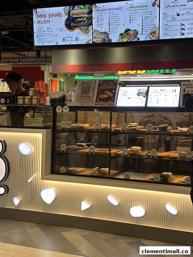 A vibrant view of Munchi Pancakes' counter, showcasing their pancake display and detailed menu boards.