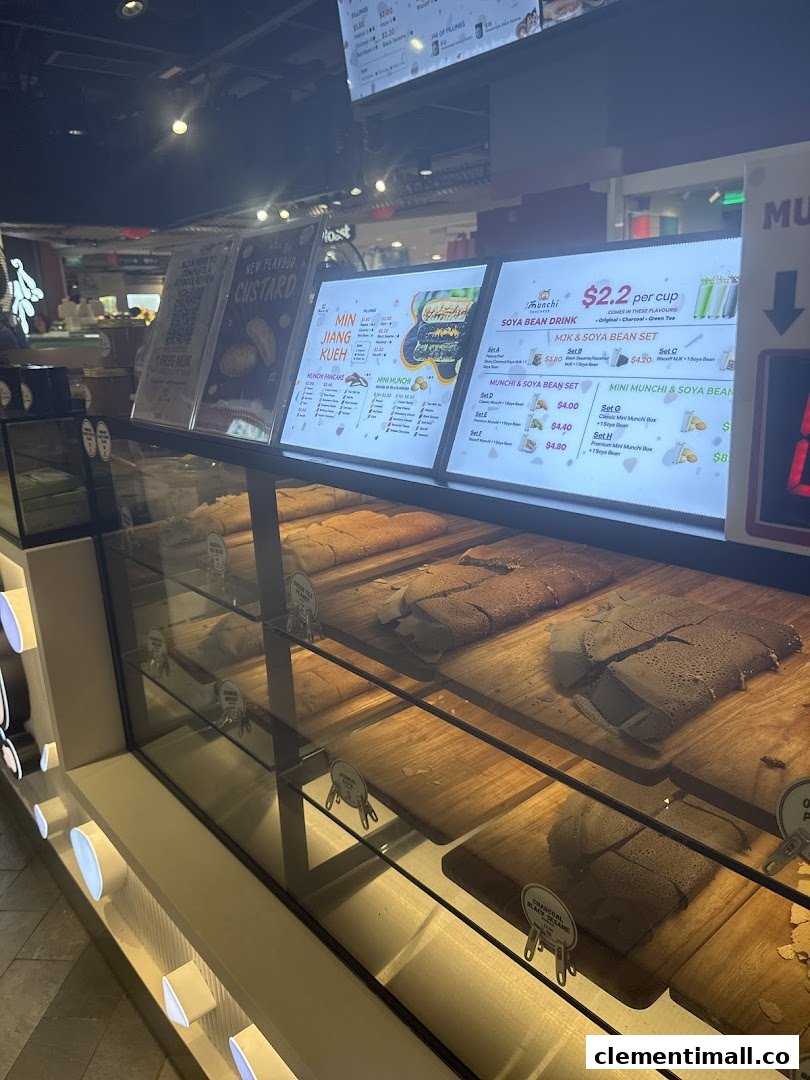 A display case showcasing various Munchi pancakes with illuminated menu boards in the background.