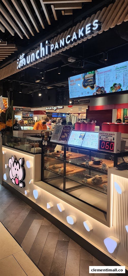 A vibrant counter at Munchi Pancakes showcasing their delicious pancake offerings and menu boards.