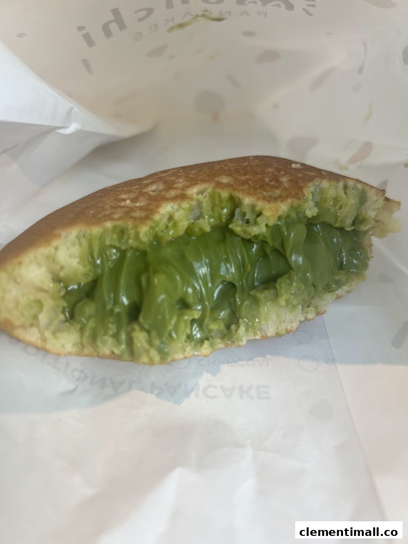 A close-up of a Munchi pancake filled with a vibrant green, creamy filling, likely matcha.