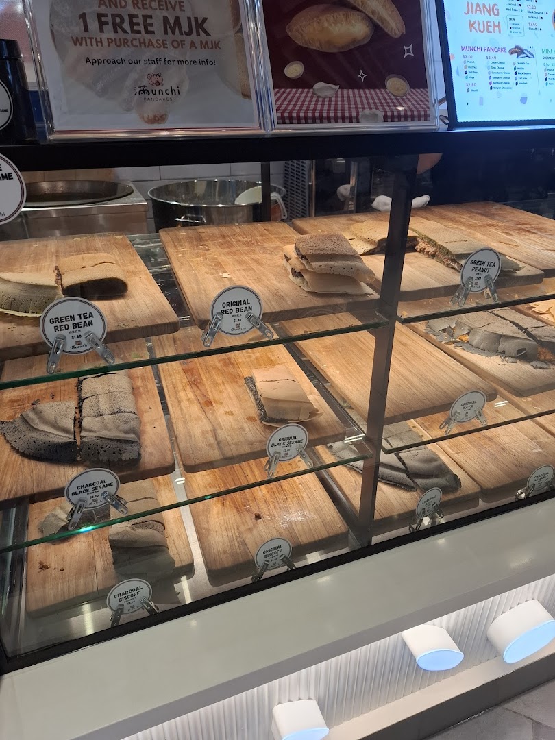 A vibrant display case showcasing a variety of freshly made Munchi Pancakes in different flavors.