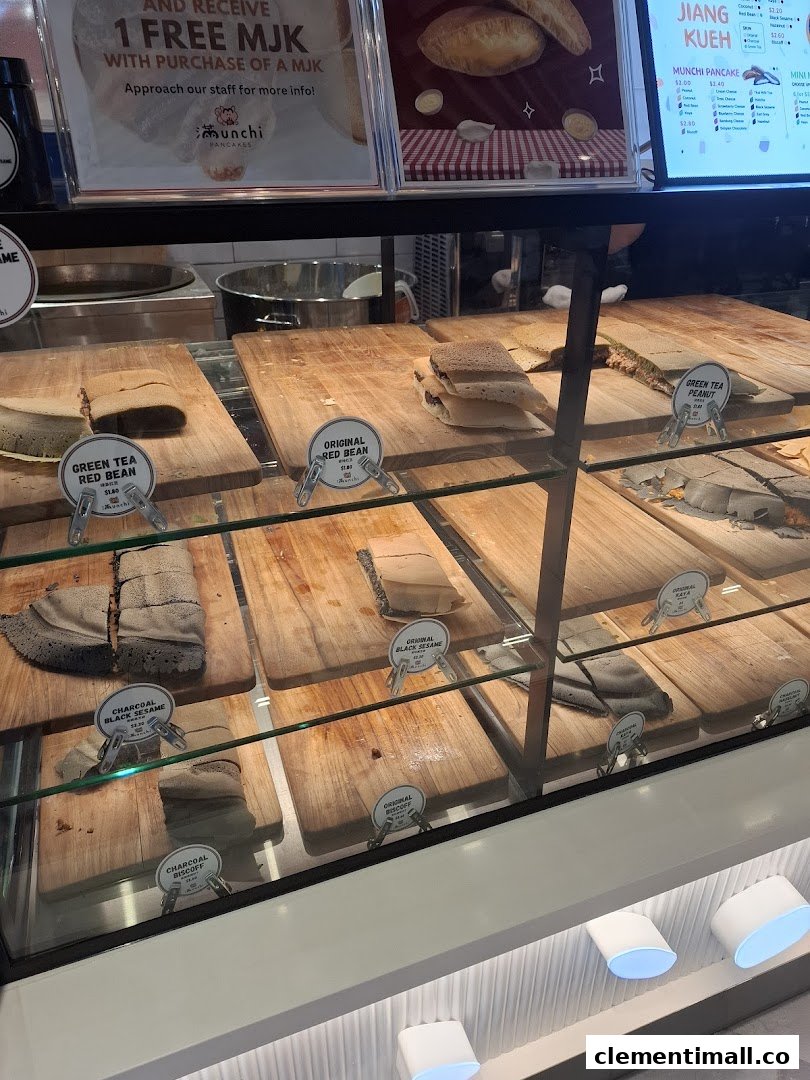 A vibrant display case showcasing a variety of freshly made Munchi Pancakes in different flavors.