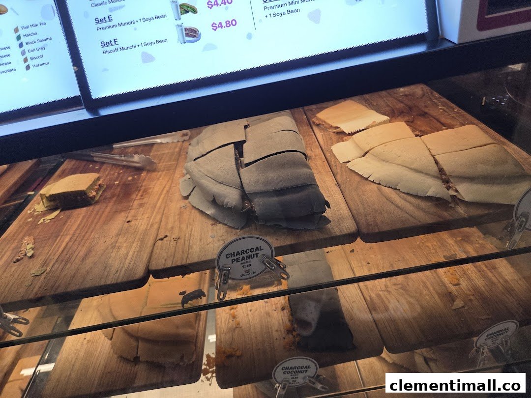 A display case at Munchi Pancakes showcasing various pancake flavors and a digital menu.