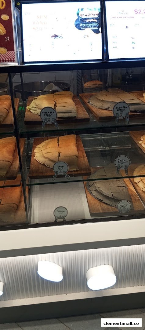 A display case showcasing various sliced Munchi Pancakes, including green tea, charcoal, and original flavors.