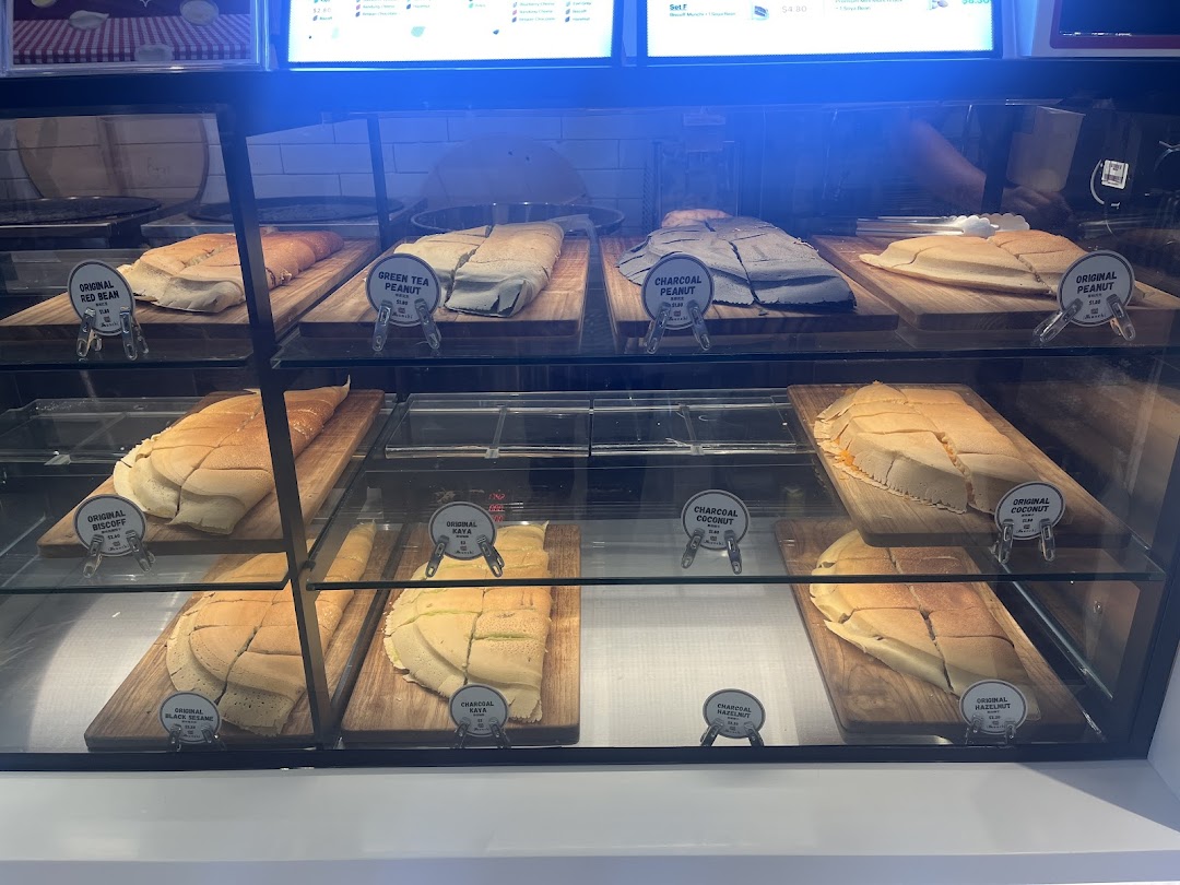 A vibrant display case showcasing various freshly made Munchi Pancakes with diverse fillings.