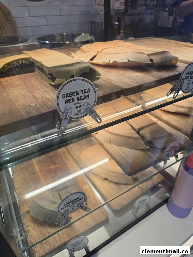 A display case showcasing various Munchi Pancakes, including Green Tea Red Bean and Charcoal Black Sesame.