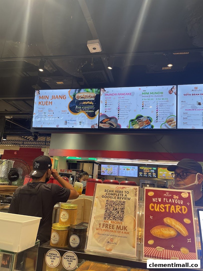 A vibrant digital menu board at Munchi Pancakes showcasing various pancake and dessert options.