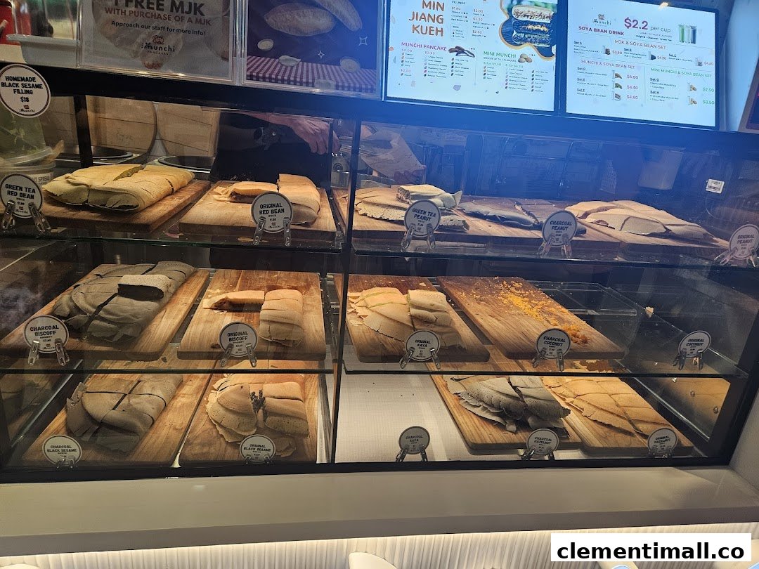 A display case showcasing various traditional pancakes with digital menu boards detailing flavors and prices.