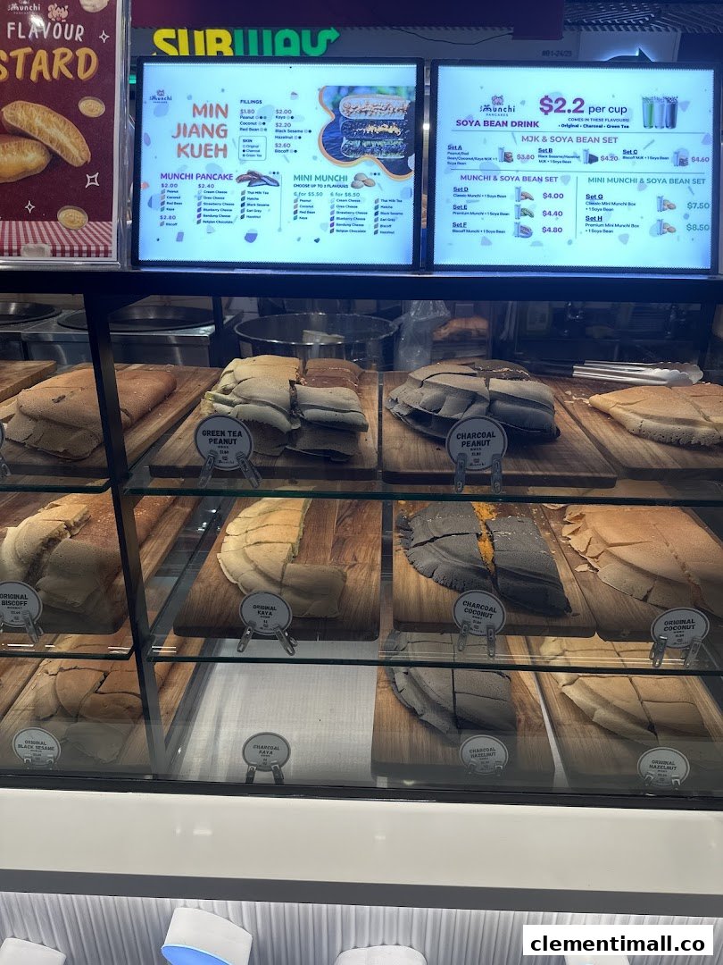 A display case showcasing various pancakes with digital menu boards listing flavors and prices.