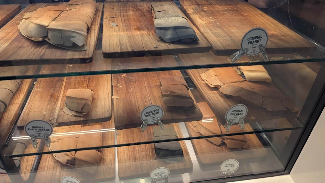 A display case showcasing various Munchi Pancakes with different fillings and prices.