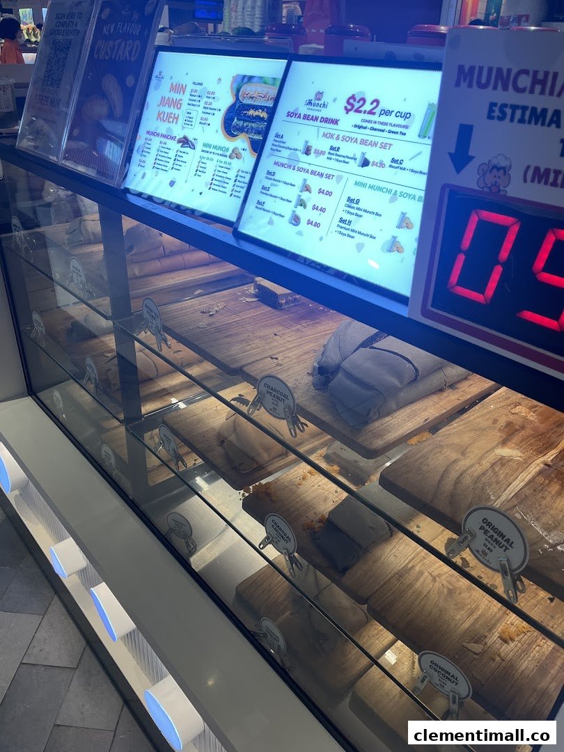 A display case showcasing pancakes and prominent menu boards for Munchi Pancakes, detailing various flavors and sets.
