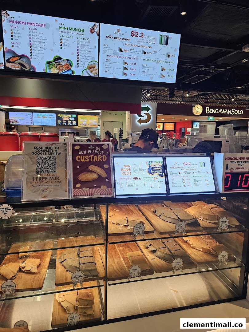 Digital menu boards and a display counter showcasing various pancakes and drinks at Munchi Pancakes.
