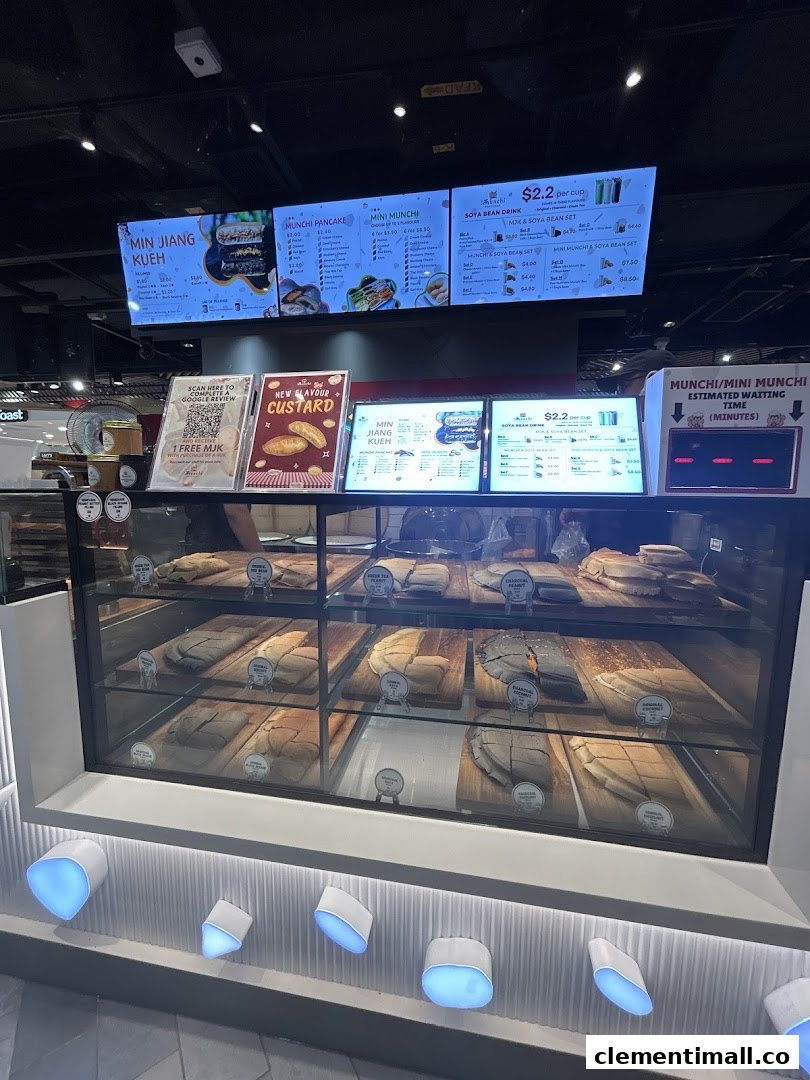 A vibrant display counter showcasing various pancakes and digital menu boards with prices and offerings.