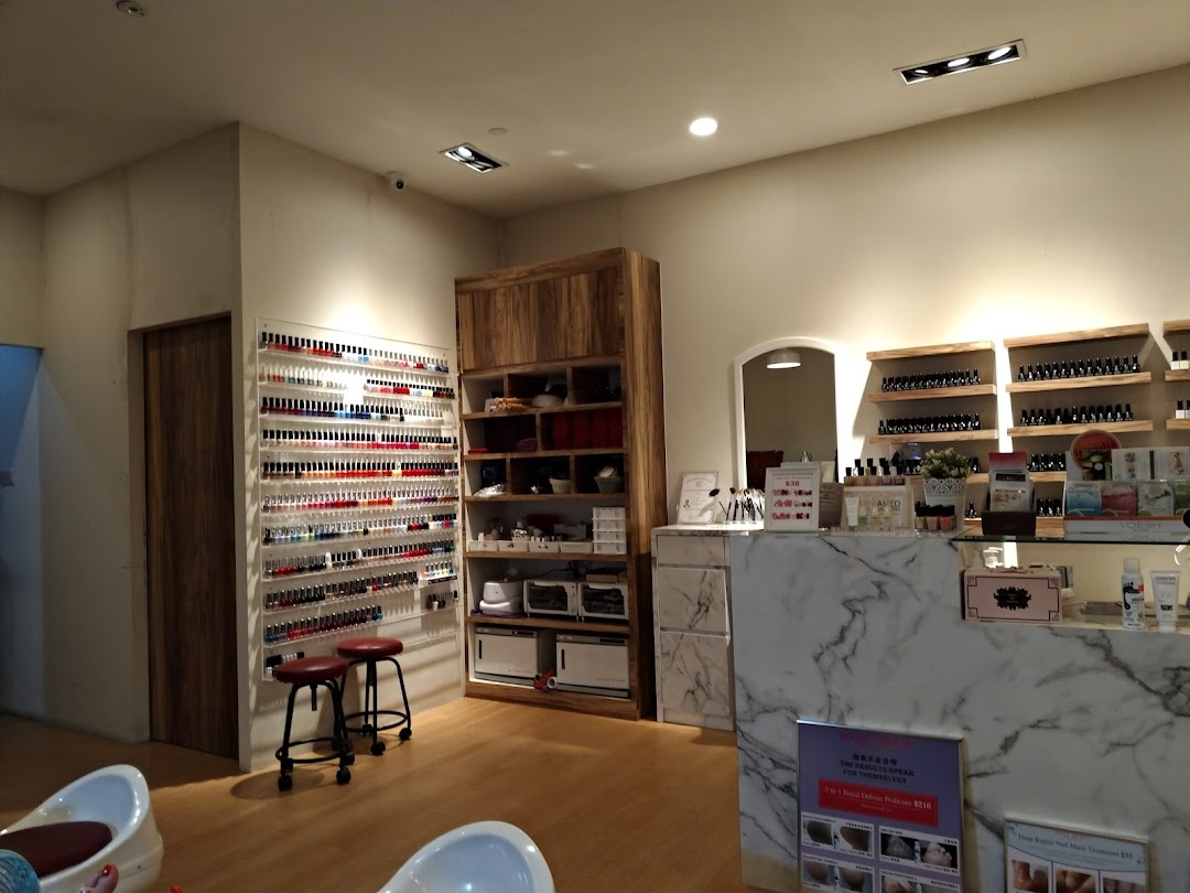 Interior view of Nailz Treats salon, featuring a vast nail polish display, service counter, and seating.