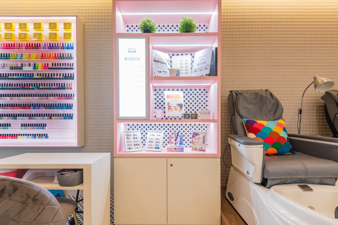 Interior view of Nailz Treats, featuring colorful nail polish displays, a service menu, and a pedicure station.