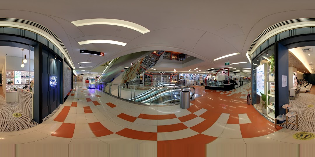 Panoramic view of a shopping mall interior featuring Nailz Treats and escalators.