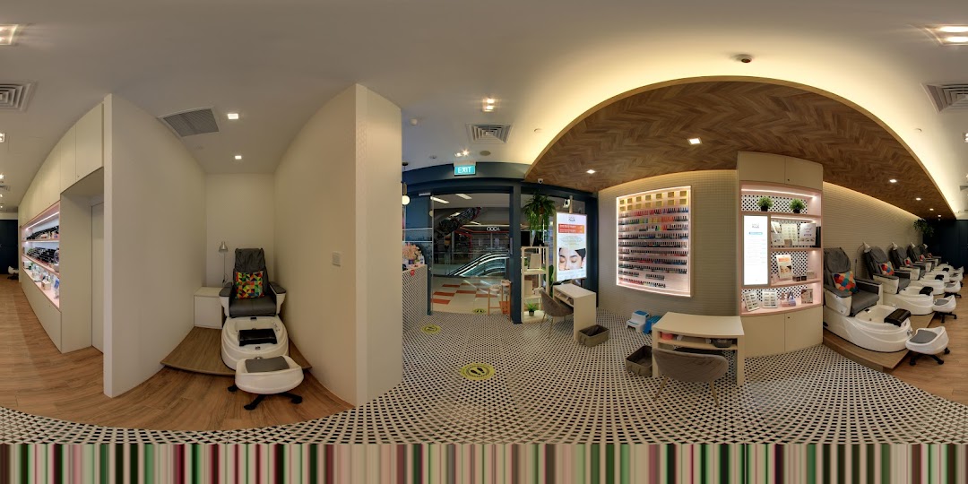 Interior view of a modern nail salon with pedicure stations and nail polish displays.