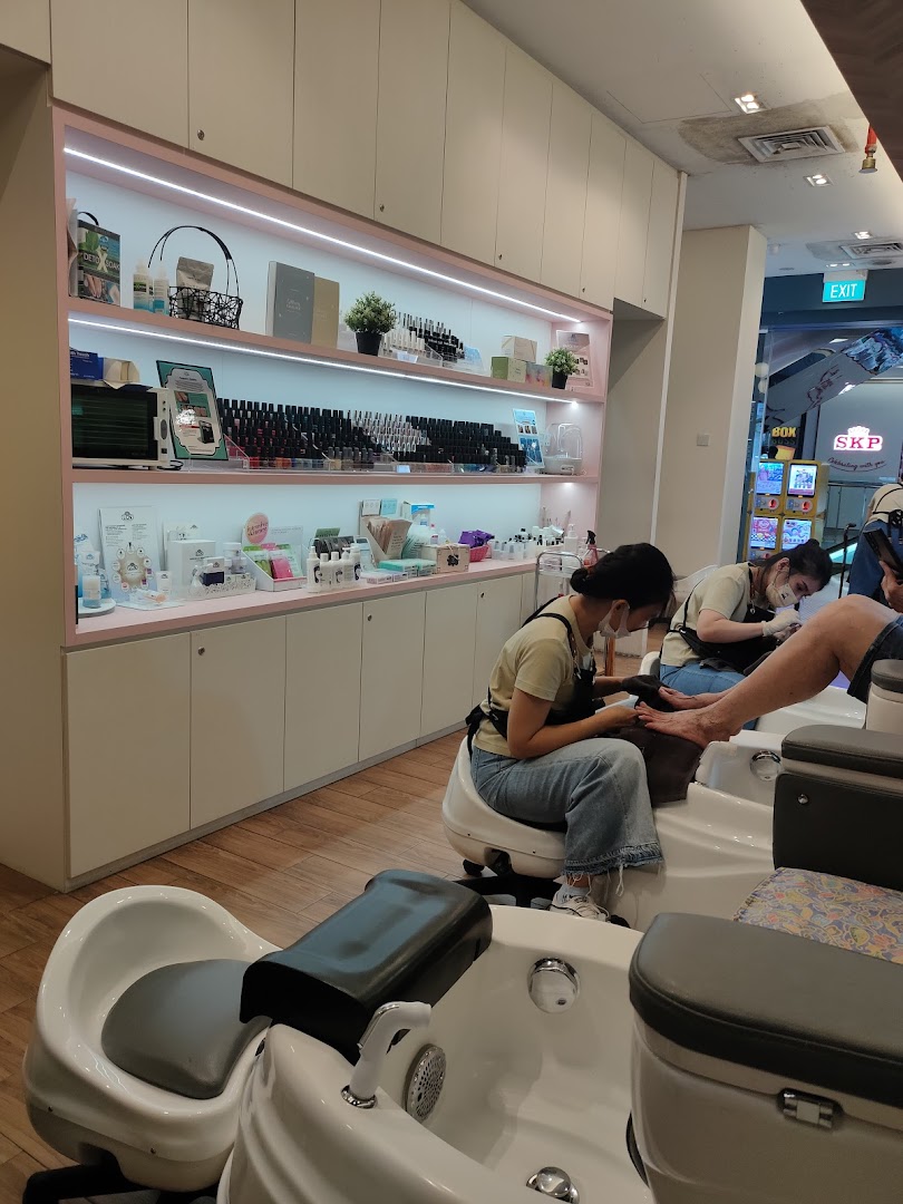 Interior view of Nailz Treats salon showing customers receiving pedicure services and product displays.