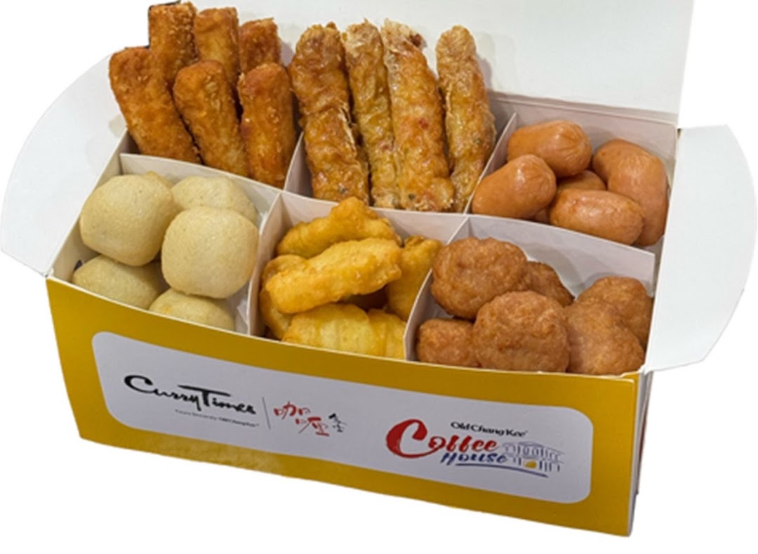 A white and yellow box filled with various fried snacks, including fish balls, sausages, and spring rolls.