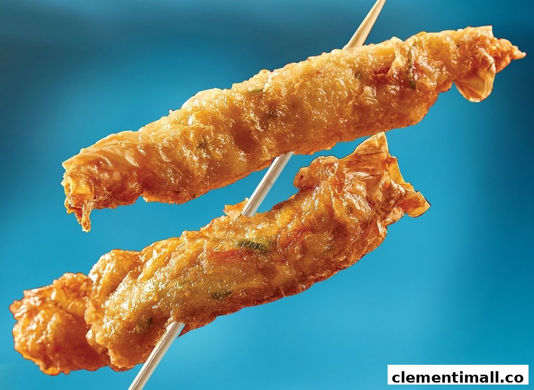 Two golden-fried snacks on skewers, showcasing their crispy texture against a blue background.