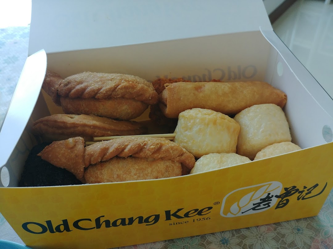 A box filled with assorted fried snacks, including curry puffs and fishballs, from Old Chang Kee.