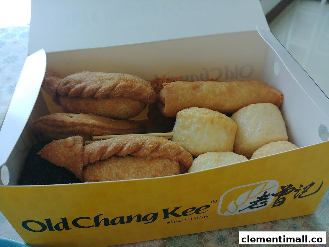 A box filled with assorted fried snacks, including curry puffs and fishballs, from Old Chang Kee.