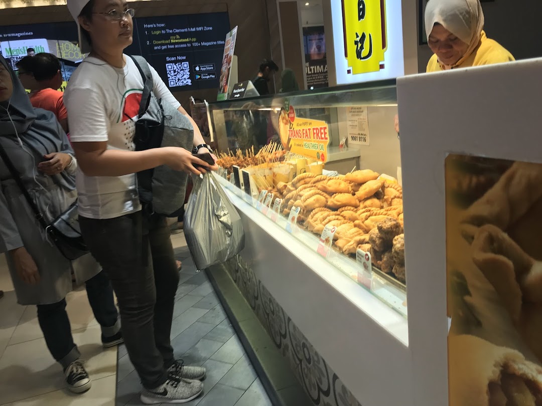 Customers browse a display of golden-fried snacks and pastries at Old Chang Kee.